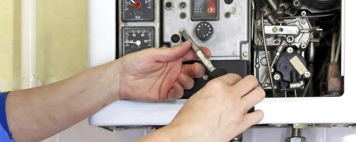 Heating repair technician adjusting boiler controls and components in Tampa, FL