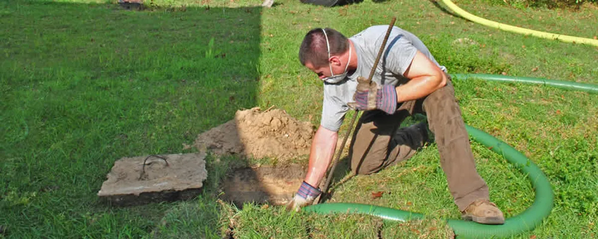 Septic pumping technician servicing a residential septic tank in Tampa, FL